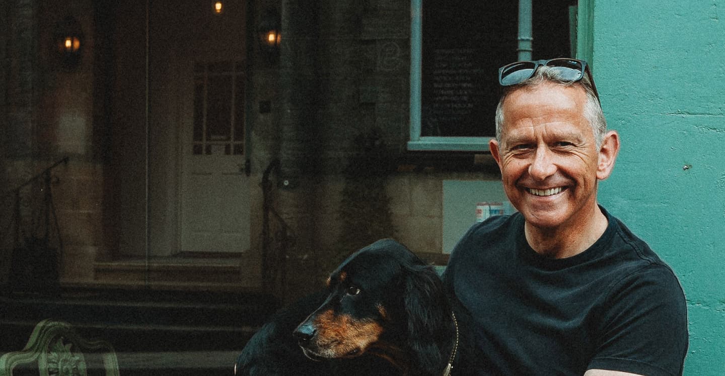 A photograph of Andrew Krisson and his dog.